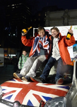 Drivers Philip Young (left) and Paul Brace enjoy their champagne moment under London's Marble Arch