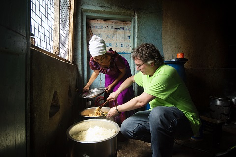 Chef Andoni Luis Aduriz helps Mama Zain Abu to serve a meal cooked using locally grown produce at her restaurant, Zai Mama Lishe in Babati, Tanzania.  