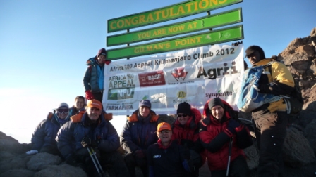 The Kilimanjaro Challenge Team unfurls the banner at Gilman's Point