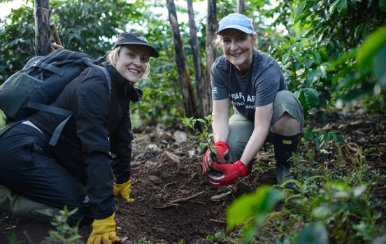 Sarah Louise Fairburn plants tree sapling in Uganda