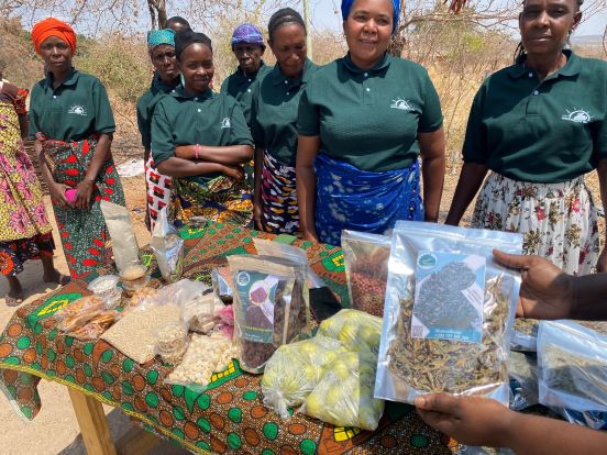 The Mwagnaza women's group standing behind a stall selling their produce