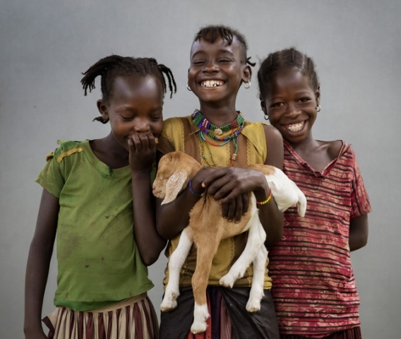 Girls holding a goat kid in South Omo, Ethiopia. Photo: Chris de Bode / Panos Pictures for Farm Africa.