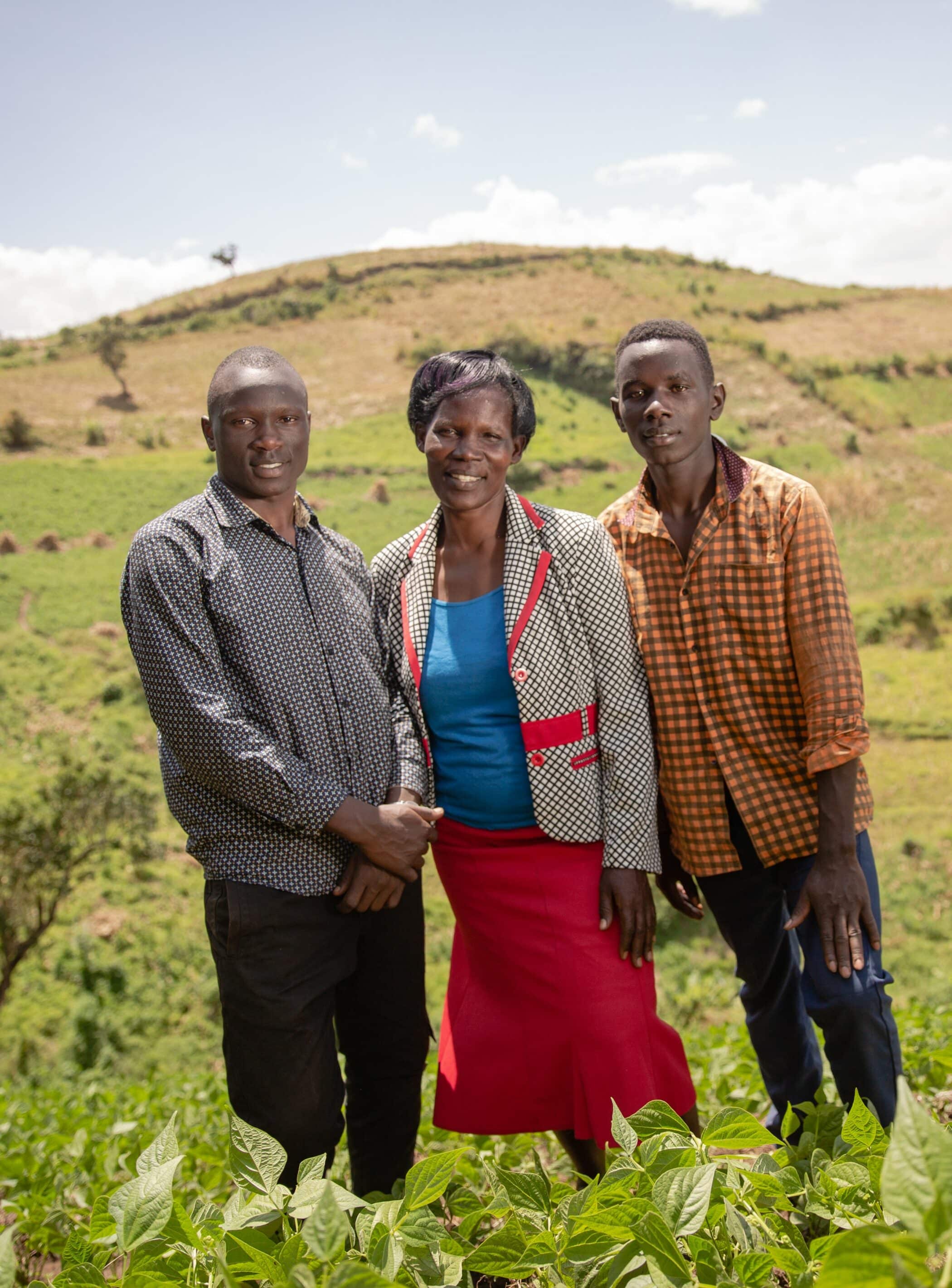 Farmer Lucy Marani with family standing in farm field in Kenya Photo: Farm Africa / Esther Mbabazi