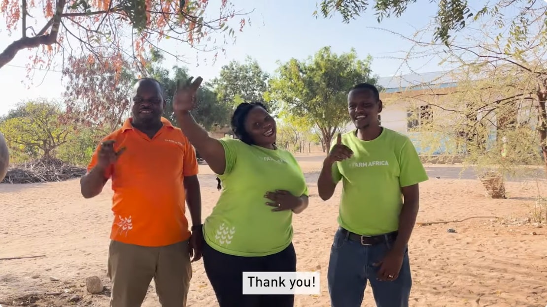 Three Farm Africa staff saying thank you.