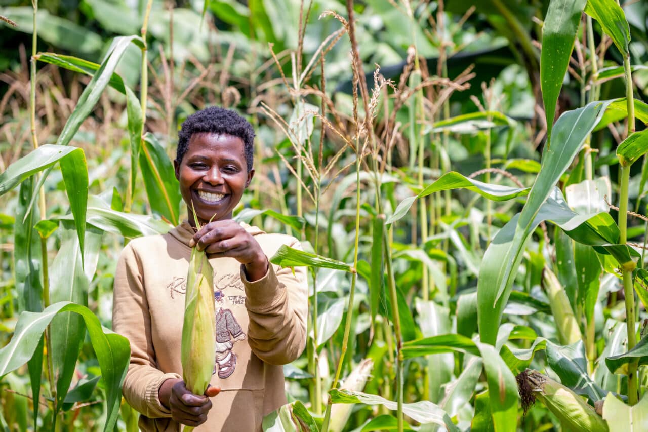 Kenyan farmer Olivanter holding maize
