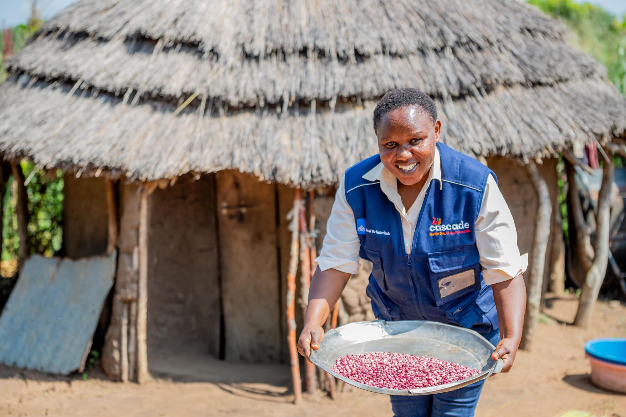 Betty Napeyok holding a platter of iron-rich beans.