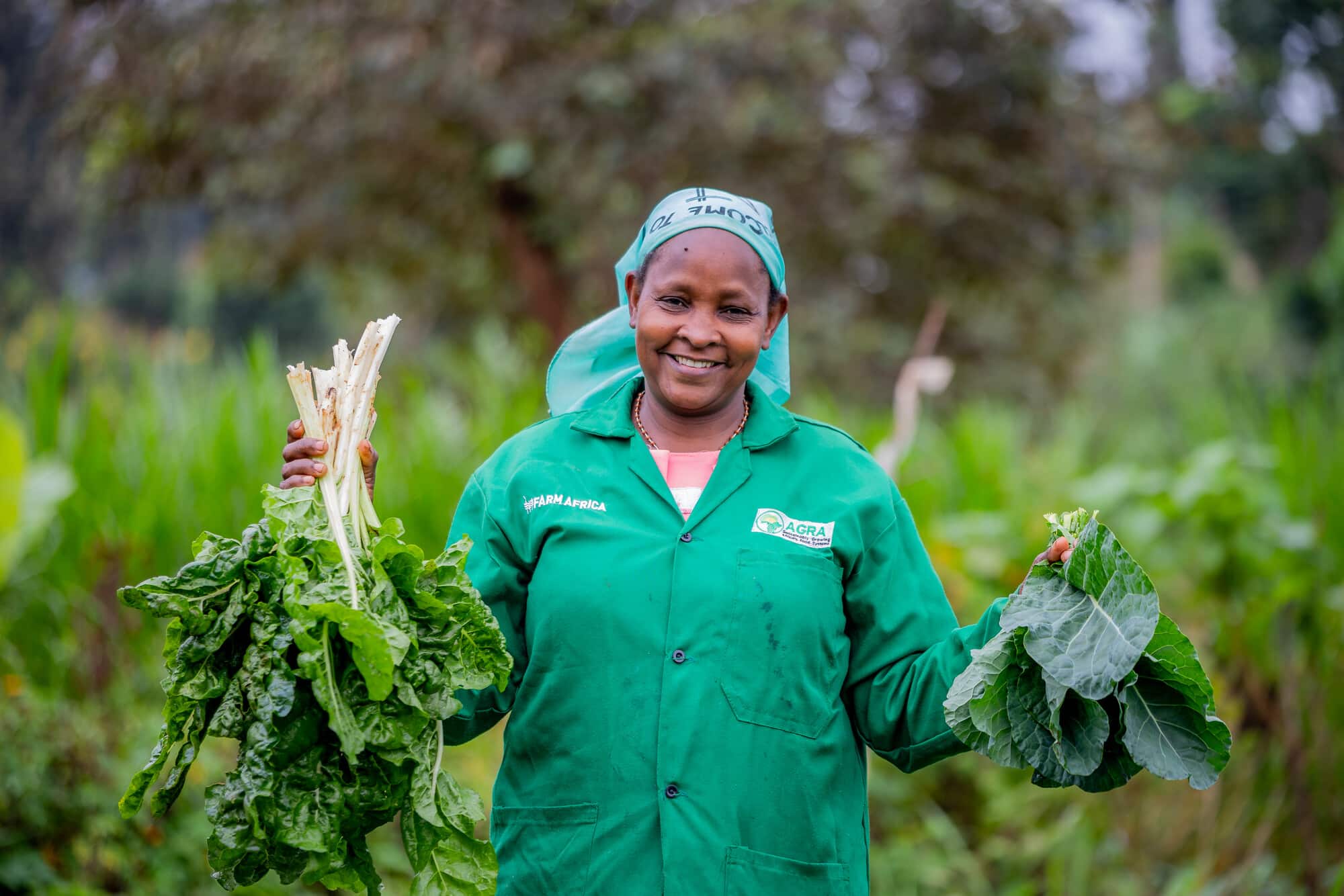 Perpetua Pius holding vegetables from her farm.Photo: Farm Africa / Bertha Lutome