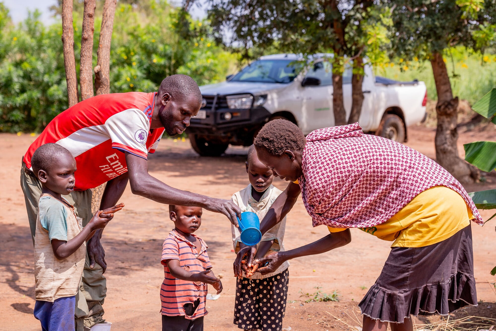 Children washing their hands before a meal.