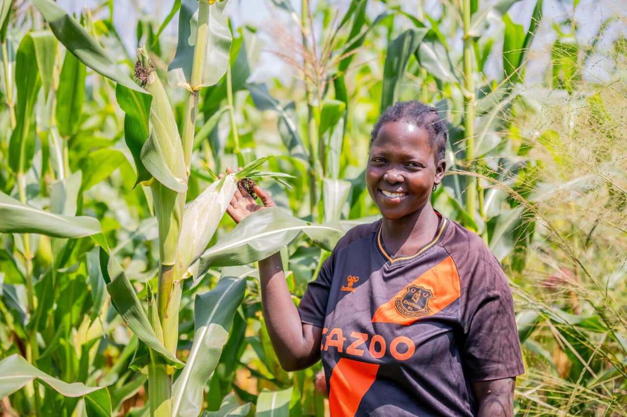 Farmer with her maize crop in Uganda.