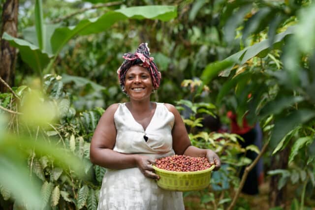 Grace, a coffee farmer from Kanungu, Uganda, with her coffee beans.