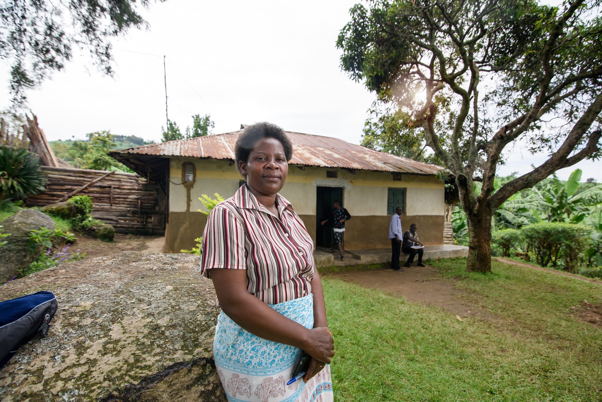 Patience proudly standing outside of her home.