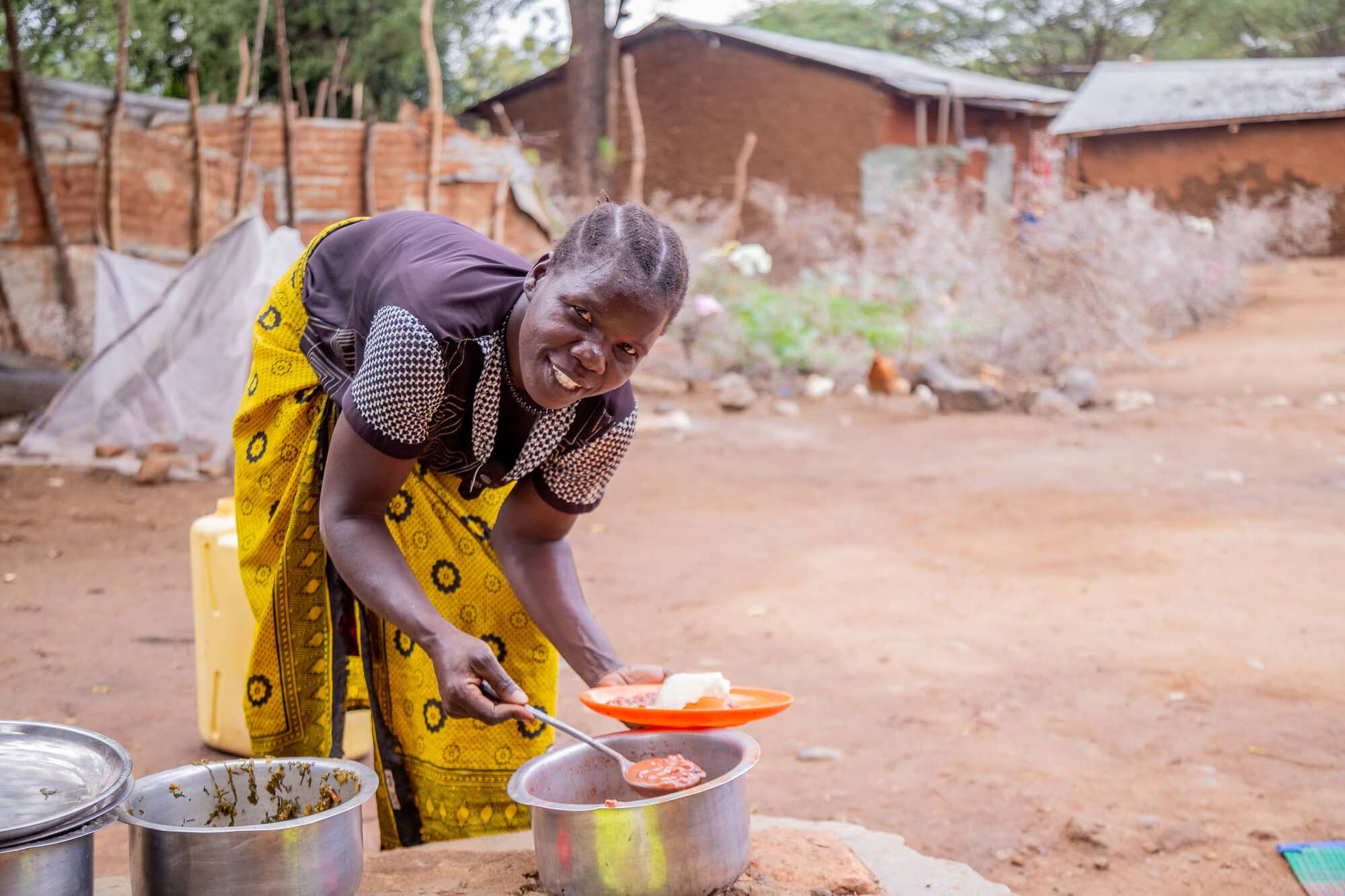 Florence Otyang, a farmer from Uganda, serving food.