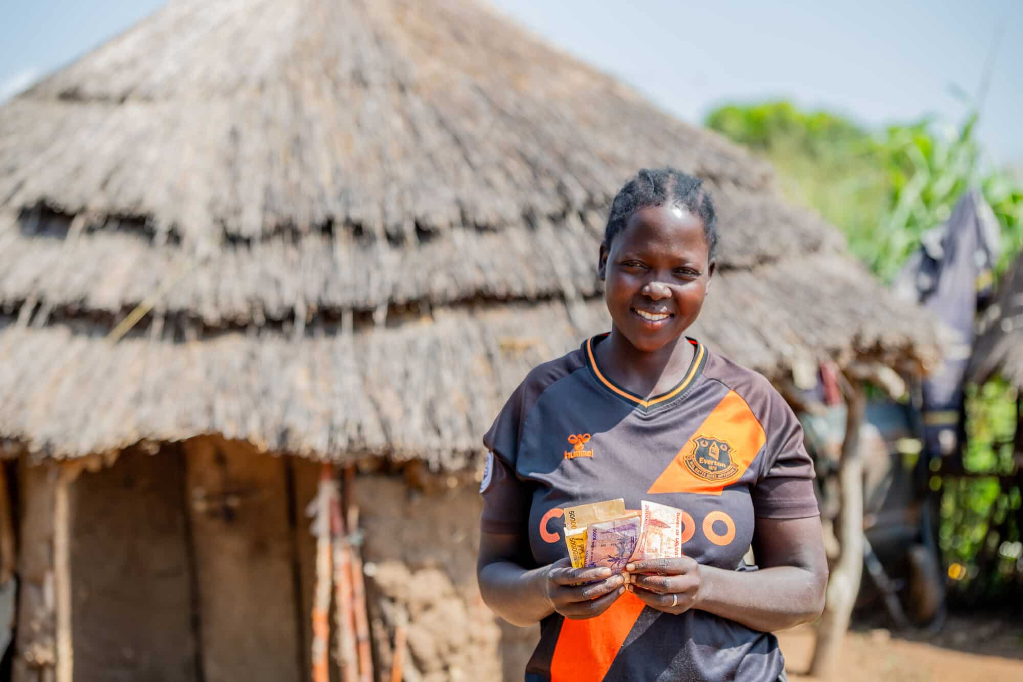 Betty Nakut, member of a farming and savings group in Napak district, Uganda, with money from the group.