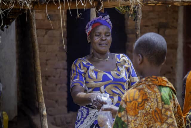 Melina Chikumbi, a farmer and entrepreneur from Tanzania selling food.