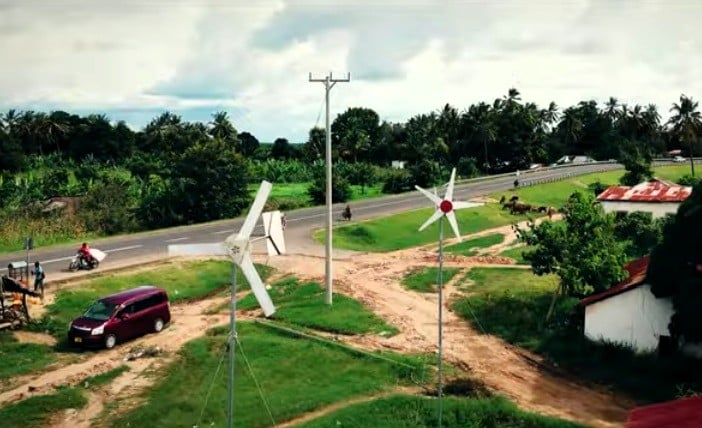 Wind turbines in front of a farming cooperative's warehouse in Tanzania.