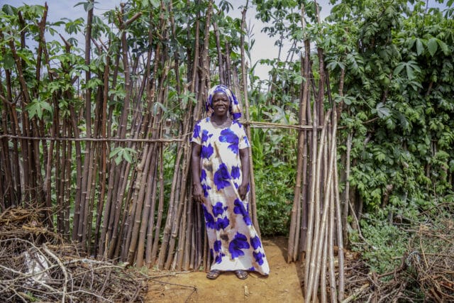 Smallholder farmer Suzana Chiwanga standing in her kitchen garden.