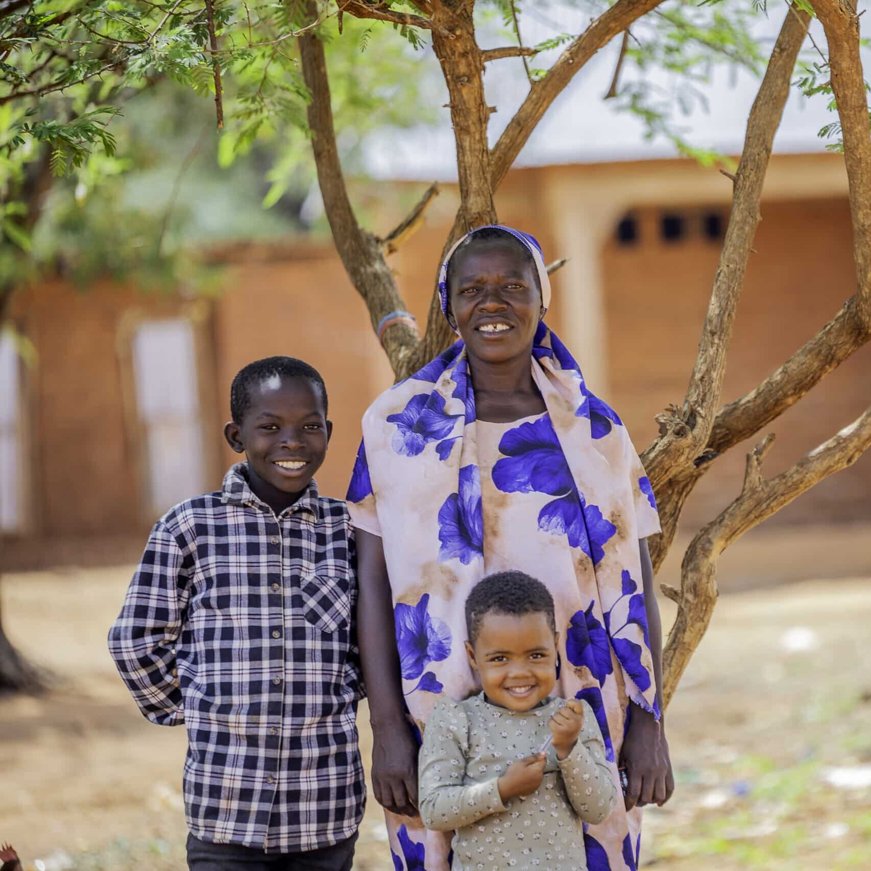 A photo of Suzana with her family. Suzana lives in Tanzania and has learnt climate-smart farming techniques along with nutrition information through the NOURISH programme